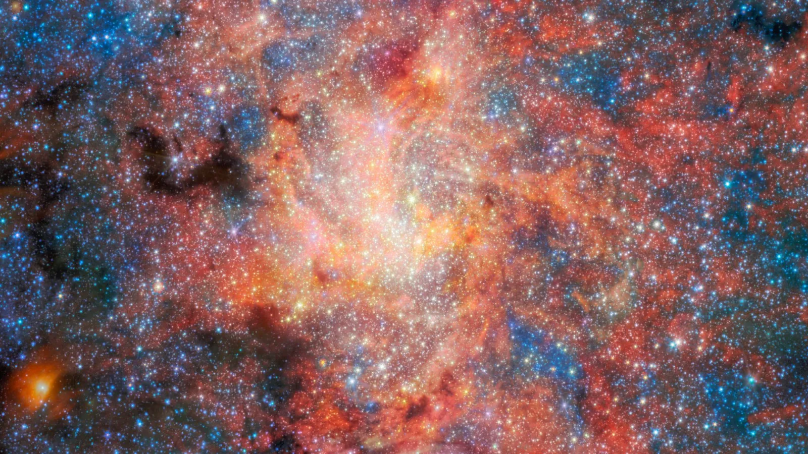 Lots of stars against a reddish structure.