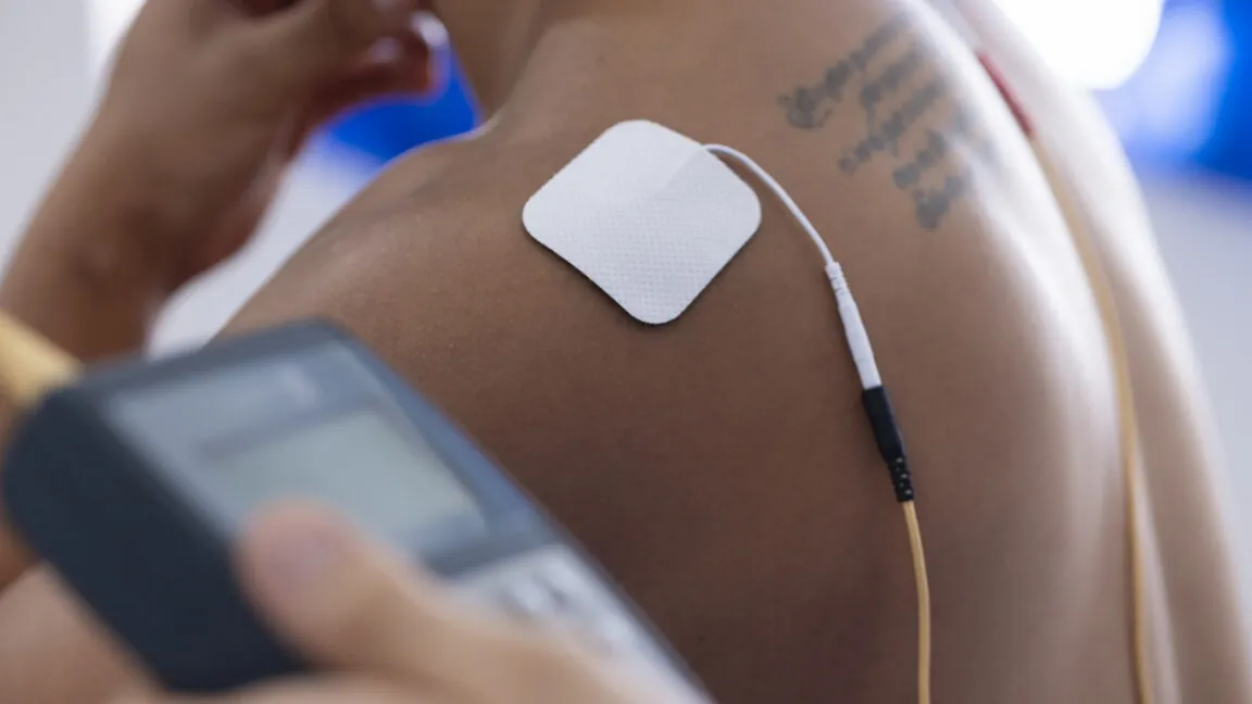 Image of an electrode stuck to a man's shoulder.